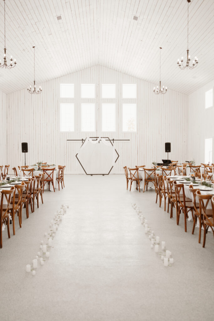 Wedding aisle decorated with candles leading up to an arch at the Grand Ivory