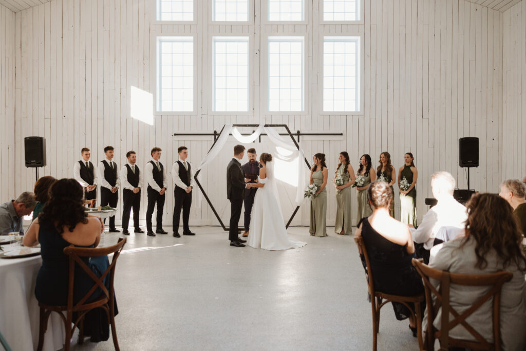 Bride and groom holding hands during winter wedding ceremony at Grand Ivory Moncton New Brunswick