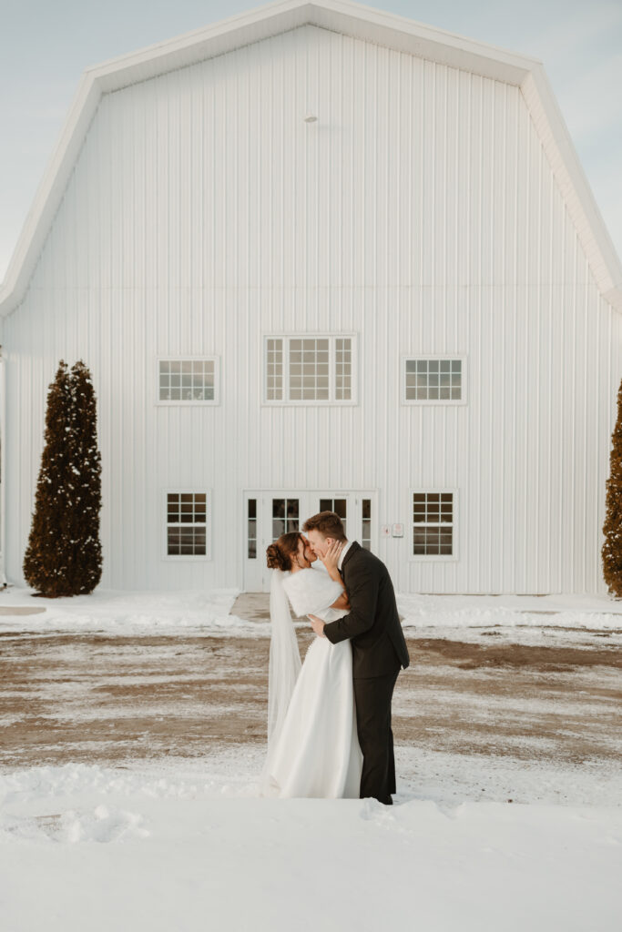 Bride and groom kissing in the snow at the Grand Ivory