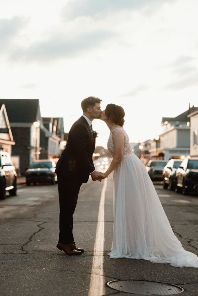 Bride and groom sunset photos kissing in Main Street St. Andrews NB