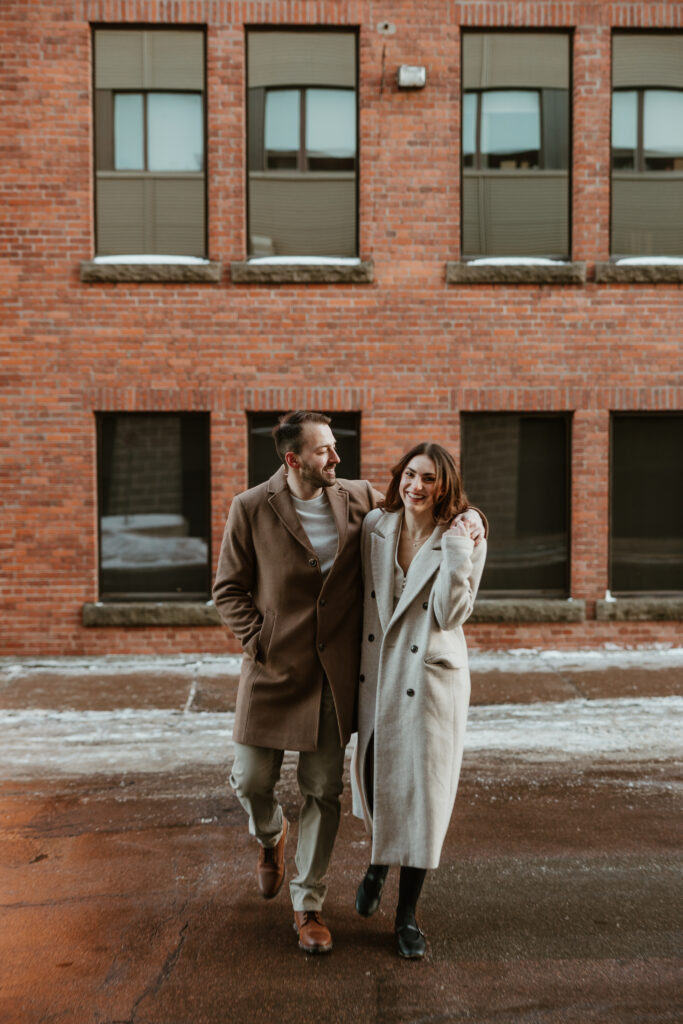 couple arm in arm walking downtown