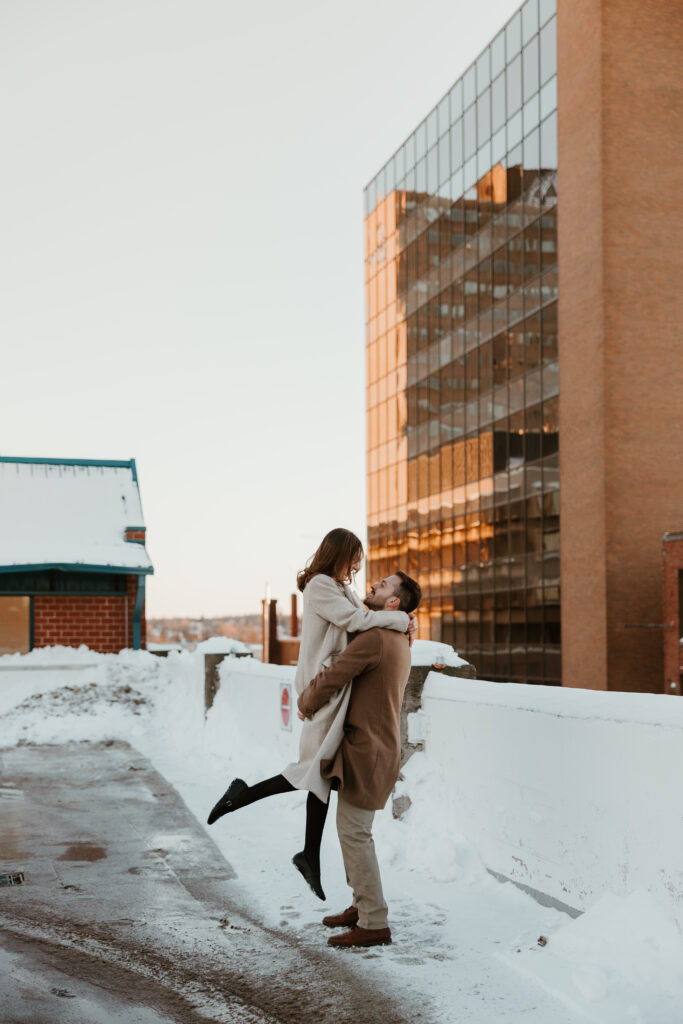 couple picking up and spinning during engagement photoshoot