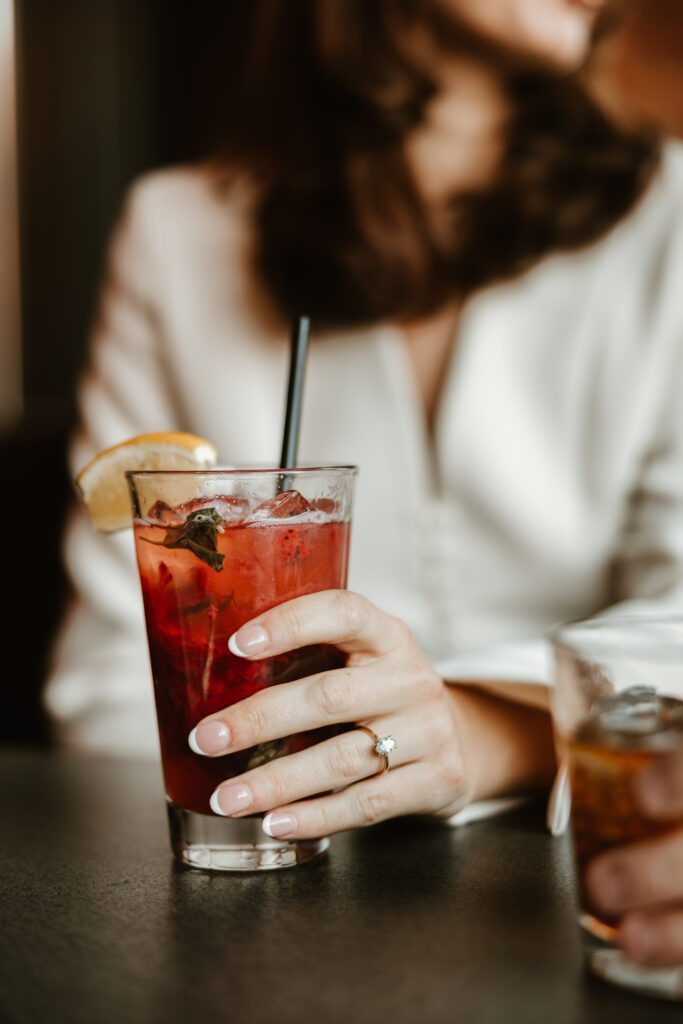 close up of drinks and engagement ring during downtown engagement session