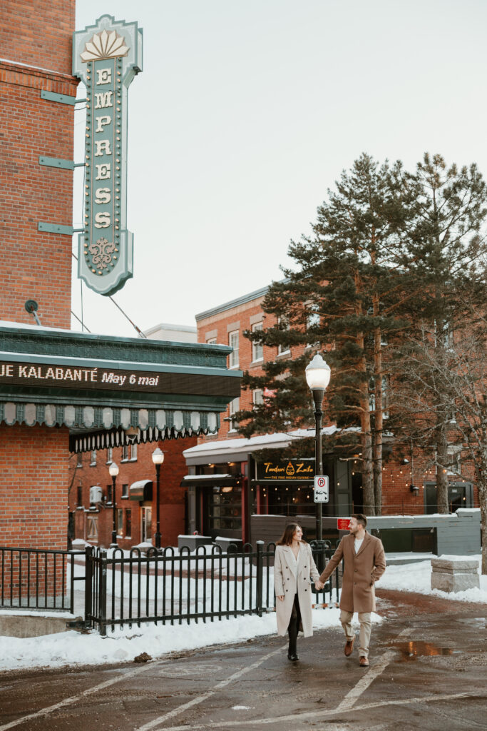 couple holding hands walking in downtown streets