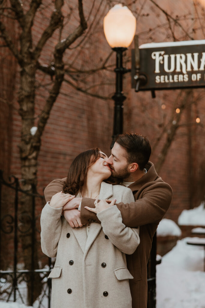 man holding women kissing during outside engagement pictures