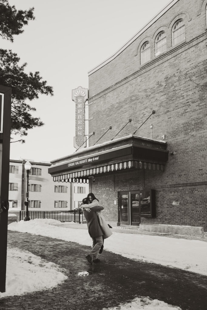 couple swinging together in front of capitol theatre in Moncton NB