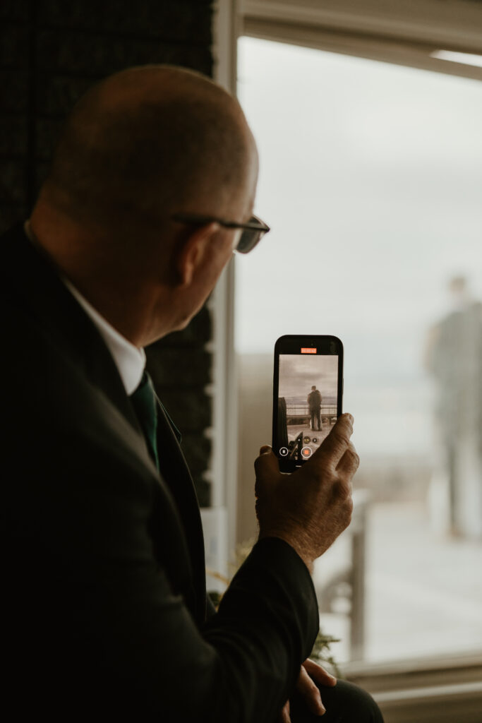 father of the bride recording first dance from inside
