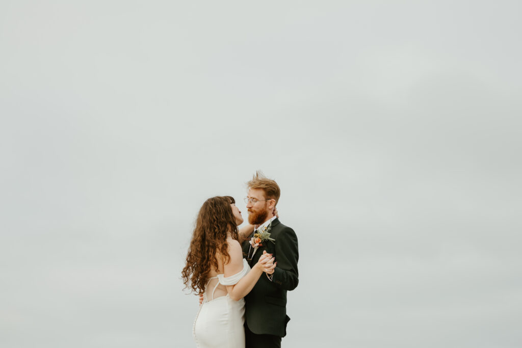 bride and groom first dance by the ocean