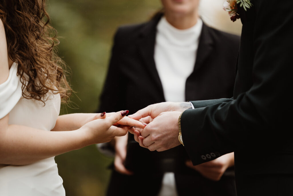 exchanging of rings at fall wedding Irishtown Nature Park