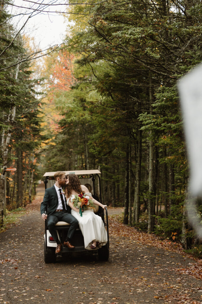 bride and groom leaving in a golf cart after wedding ceremony at irishtown nature park