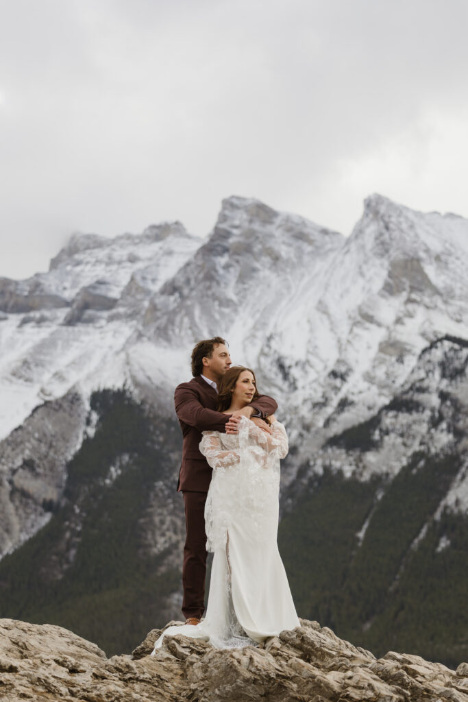 Lake Minnewanka elopement couple in front of mountains
