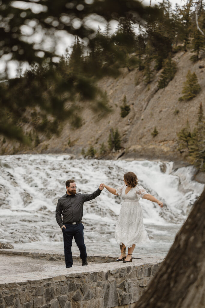 Engagement pictures in front of Bow Falls Banff Alberta