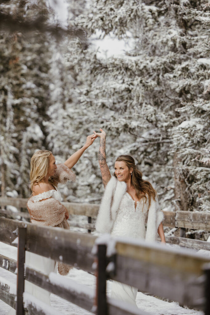 Brides spinning on path at Summit Ridge during elopement 
