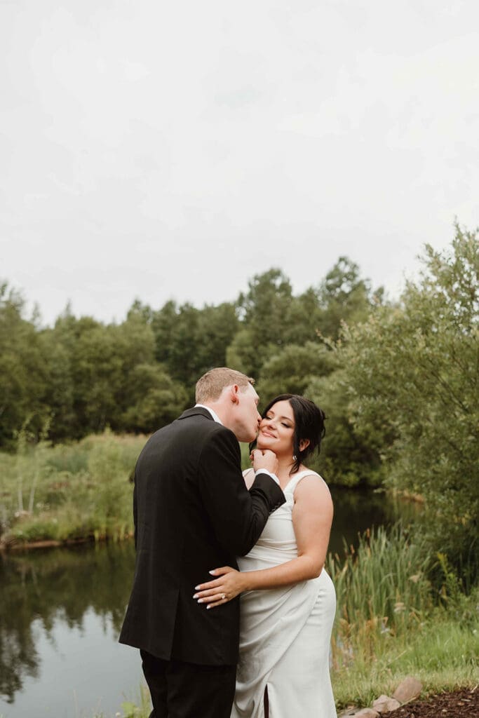 Pregnant bride standing outside The Pavilion greenhouse wedding venue Moncton